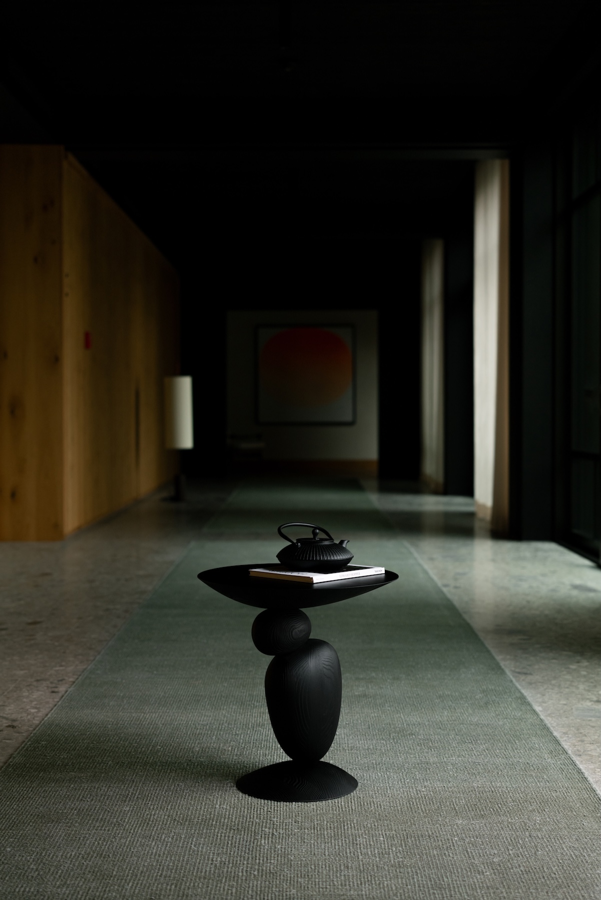 Schwarzer Beistelltisch LIGNA in einem dunklen Flur mit Kunstwerk – Interior Design von Thomas Mang